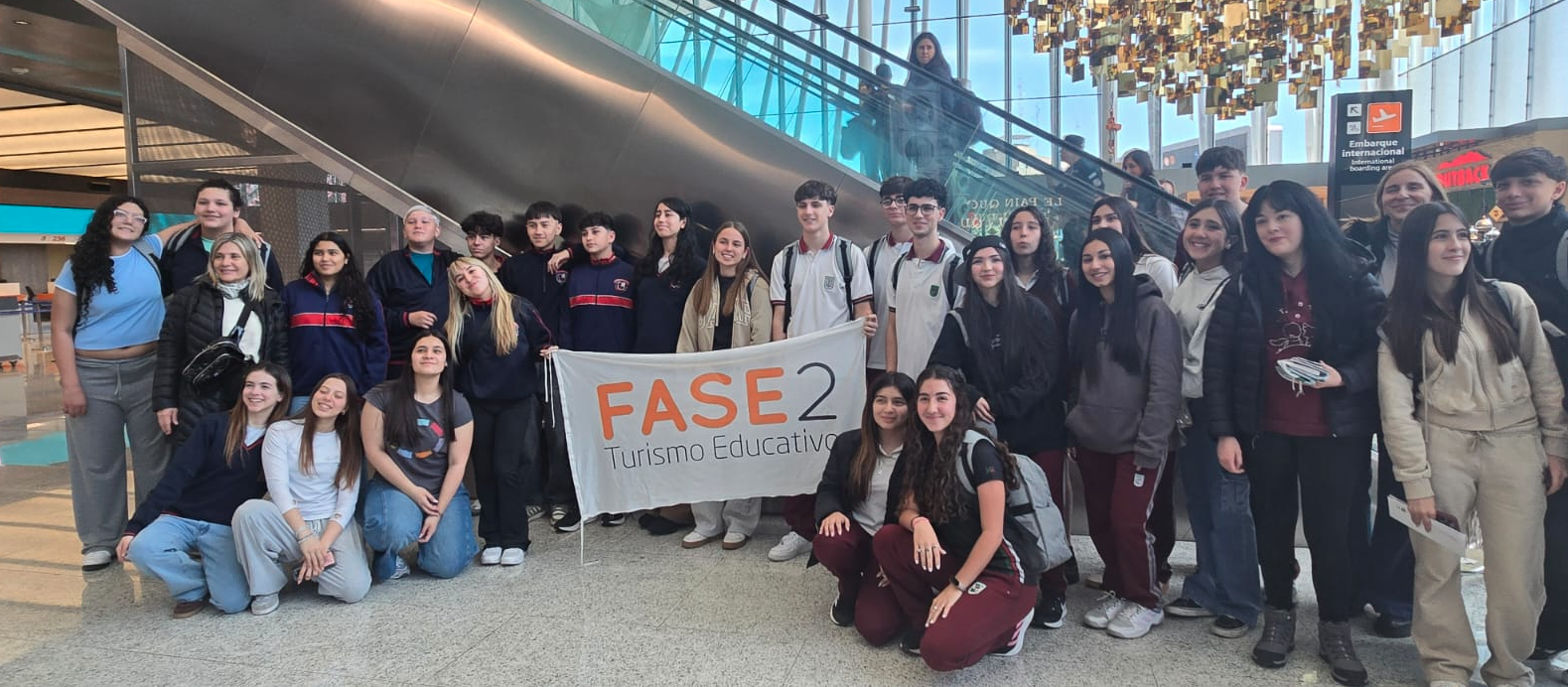 Group photo with educational trip banner